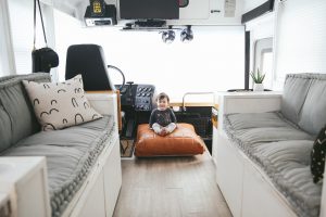 white and grey couches with baby sitting nearby