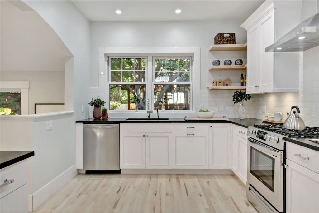 white cottage kitchen with open shelves and white oak wood floors