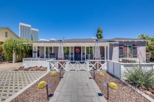 a sidewalk leads to a front courtyard