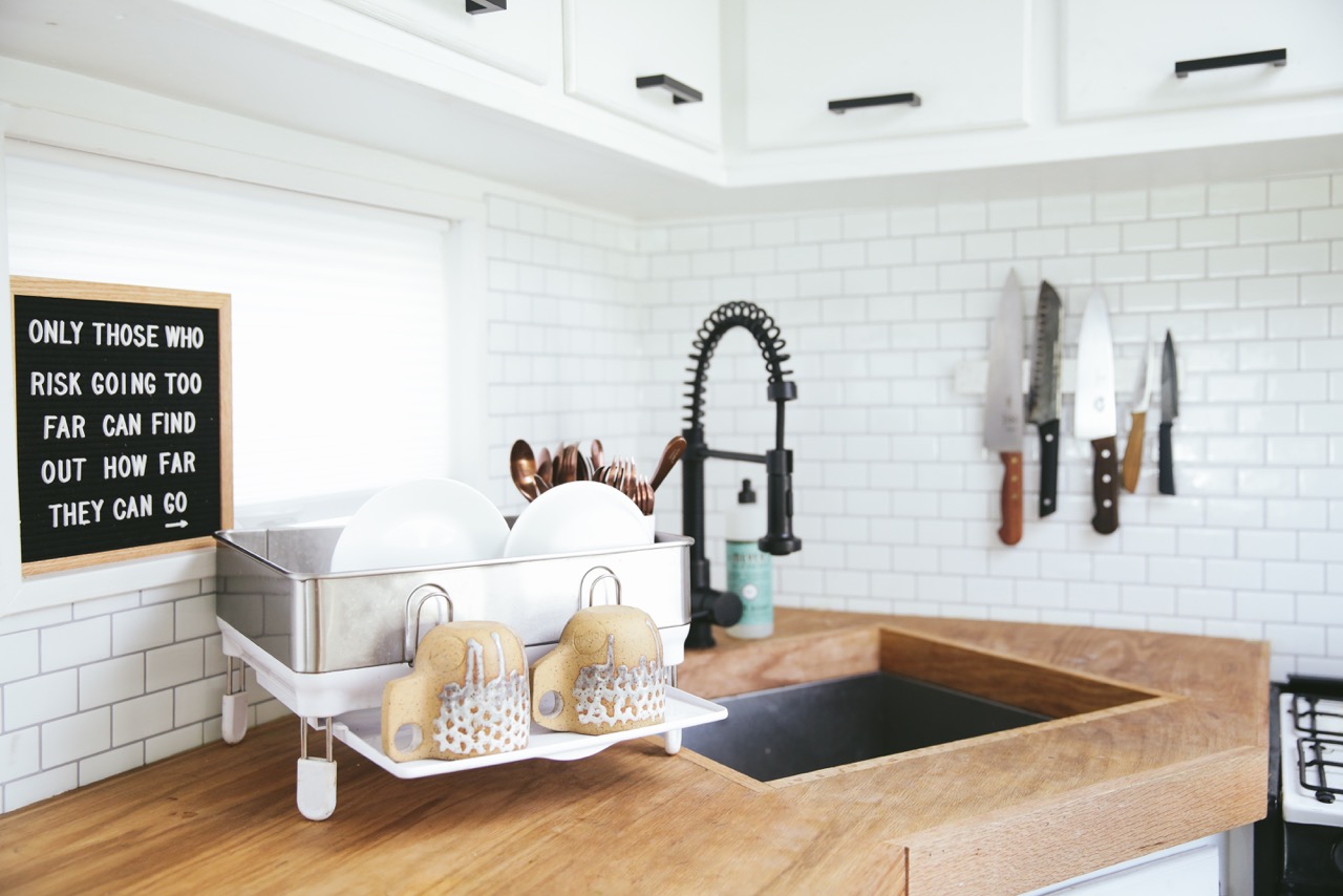 white dishes sit on a wooden countertop