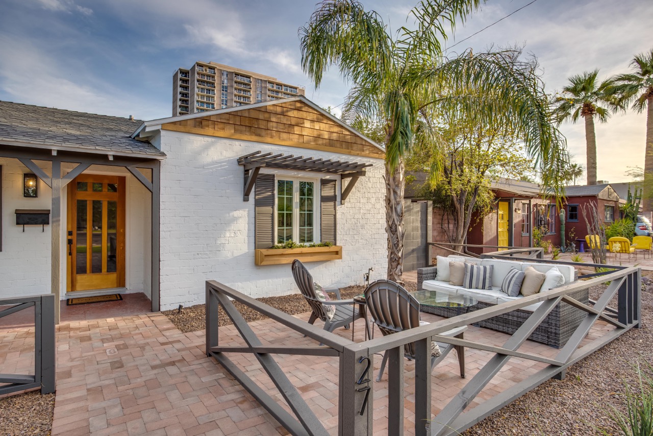 a grey fence encloses patio furniture