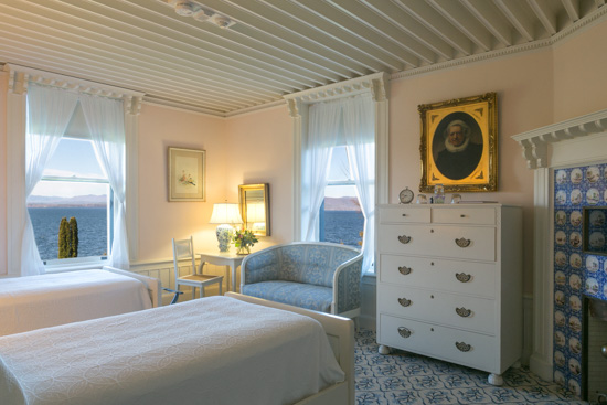 Interior shot of the Dutch Room at the Inn at Shelburne Farms, decorated in white and light blue.