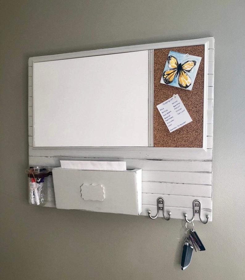 White farmhouse style dry-erase board with a place for markers, mail and keys.