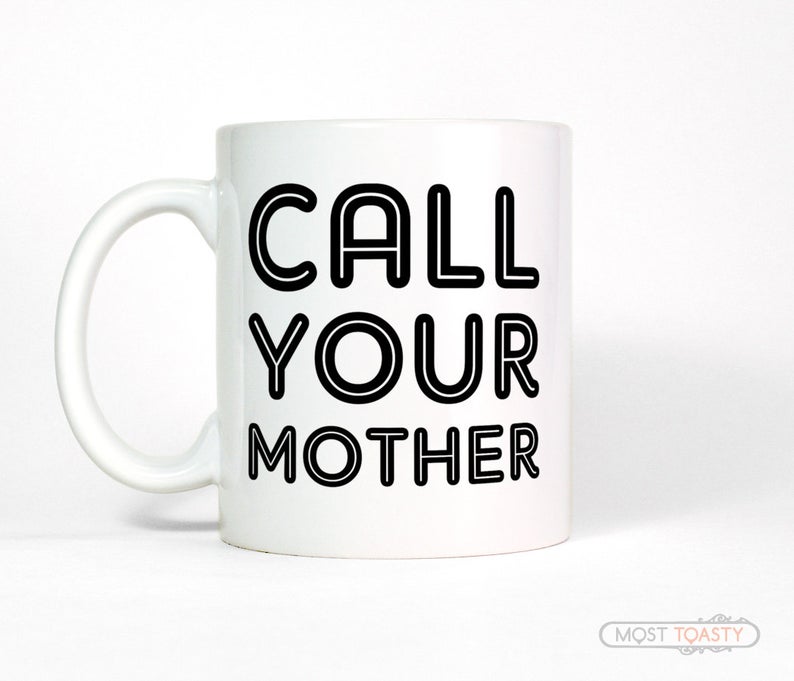 White coffee mug that says" call your mother"