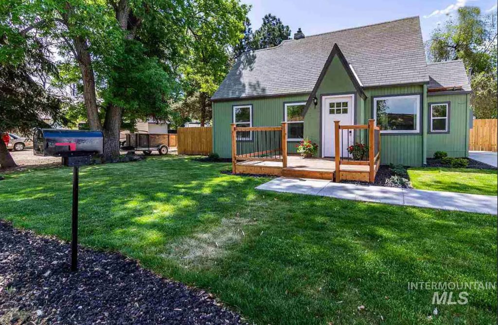 small green cottage with front deck