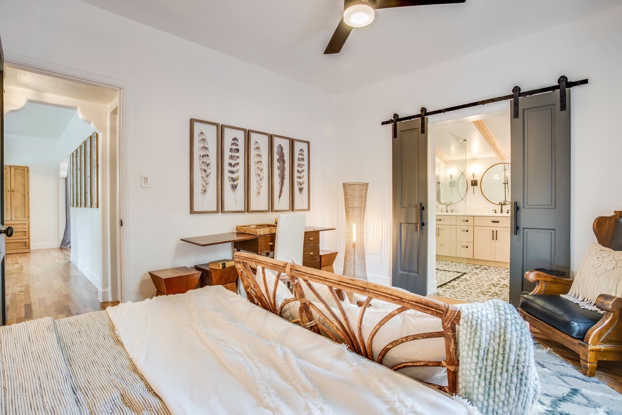 a wooden couch back sticks out among white, brown and slate grey decor