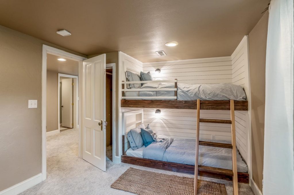 bedroom with built in bunkbed with shiplap walls