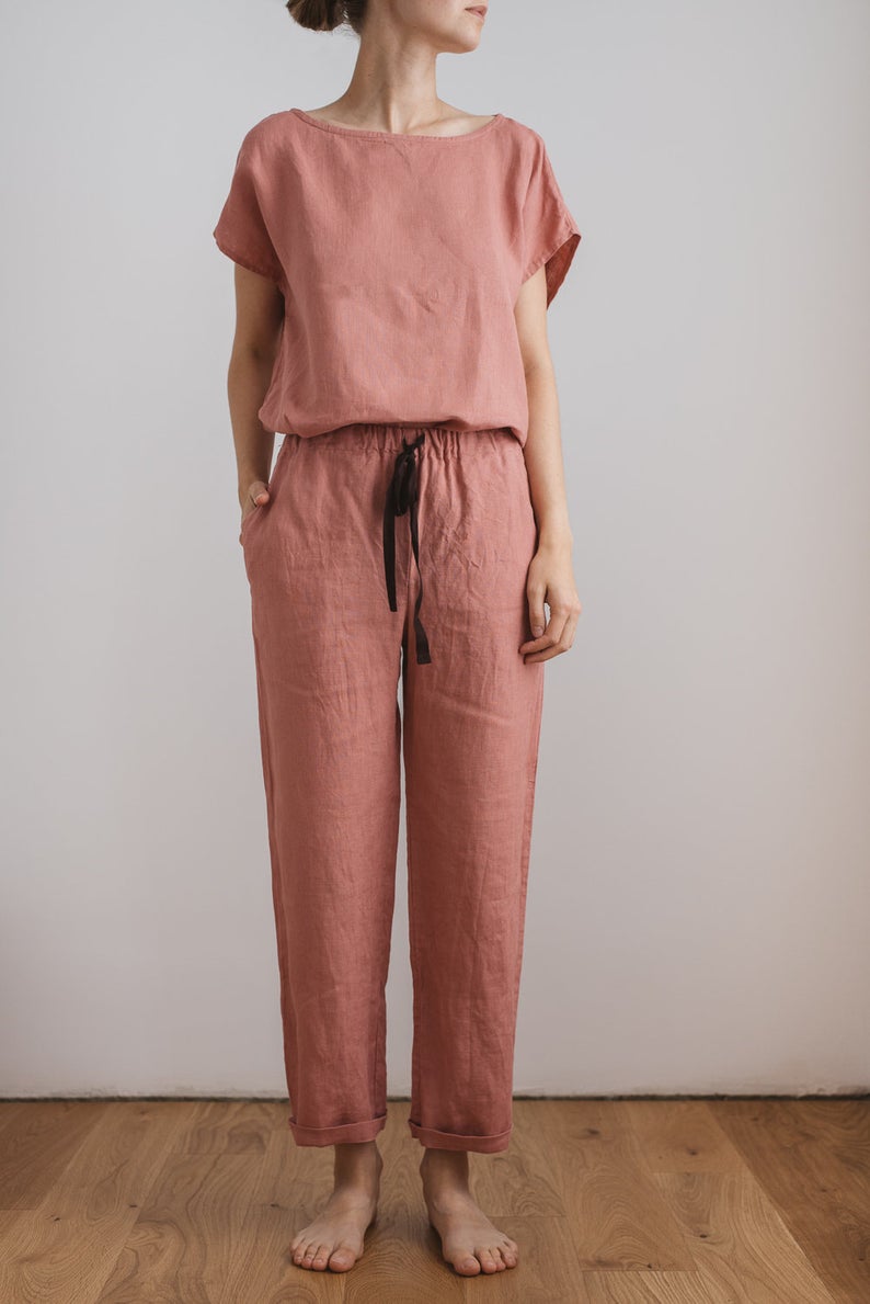 Slender woman in rose colored two piece linen pajamas with black drawstring. Dreamy jammies for your dreamy dorm.