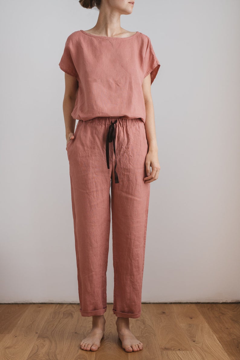 Slender woman in rose colored two piece linen pajamas with black drawstring. Dreamy jammies for your dreamy dorm. 