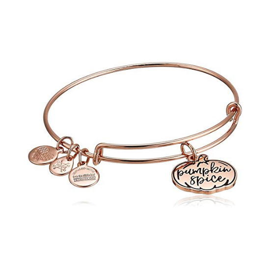 Rose gold bangle with three small charms and one larger charm in the shape of a pumpkin with "pumpkin spice" engraved on it.