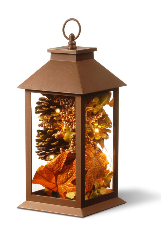 Decorative bronze lantern filled with pinecones, fall leaves and LED lights. 