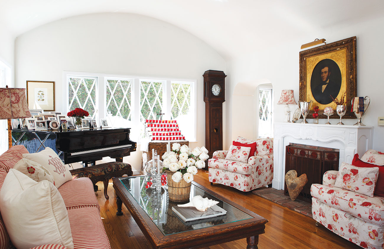 English Country Style living room complete with grandfather clock, piano and red accented furniture. 