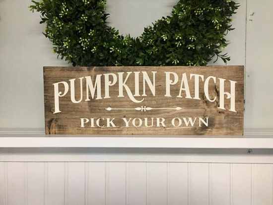 Farmhouse Halloween decor, wooden sign with white writing that says "pumpkin patch pick your own".