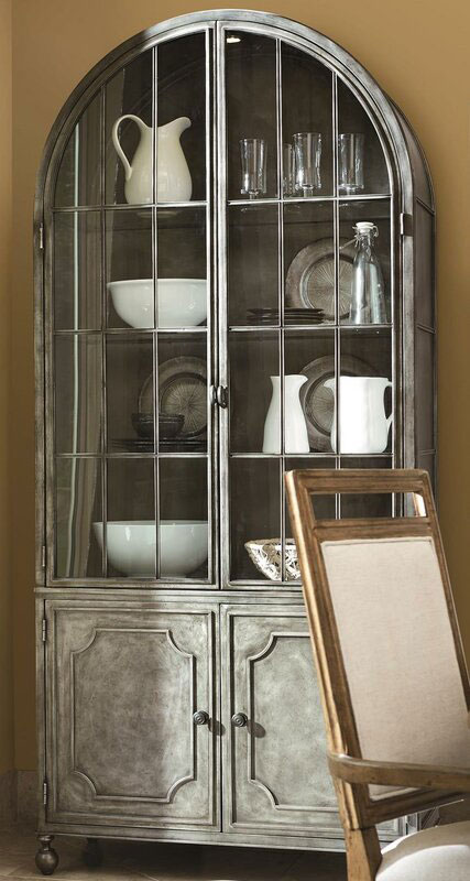 Gary toned china cabinet with white plates on display.