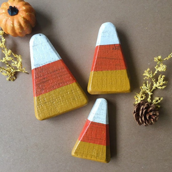 Wooden rustic decor shaped like candy corns and painted to look like candy, in various sizes.