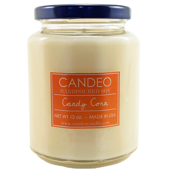 Handpoured, candy corn scented soy candle in a glass jar with a black lid. 