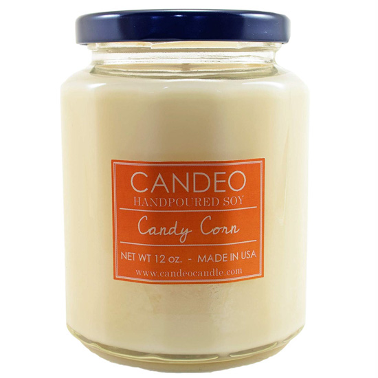 Handpoured, candy corn scented soy candle in a glass jar with a black lid.