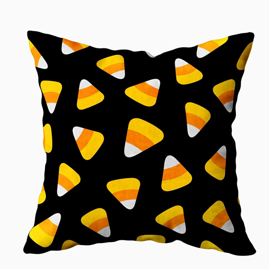 Square pillow case, black background with a candy corn design. 