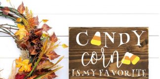 Fall wreath and a wooden home decor sign that states, "candy corn is my favorite vegetable."