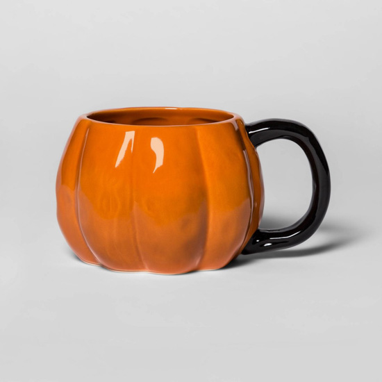 Stoneware Pumpkin Figural Mug in Orange with a black handle.