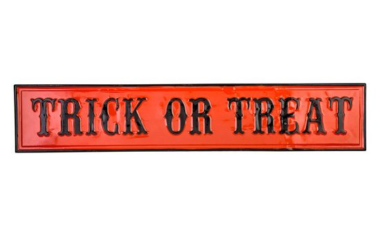 Metal wall decor orange with black trim and writing that says "trick or treat".