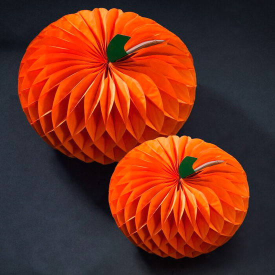 Two different sized bright orange halloween pumpkins made of paper.