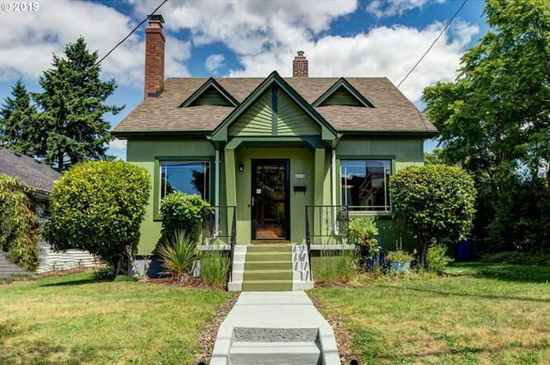 Cement steps and walkway to qa storybook style cottage with green and dark green accents in Portland, Oregon. 