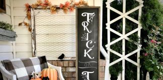 Fall porch accented with various shades and sizes of pumpkins and featuring a large trick or treat wooden sign.