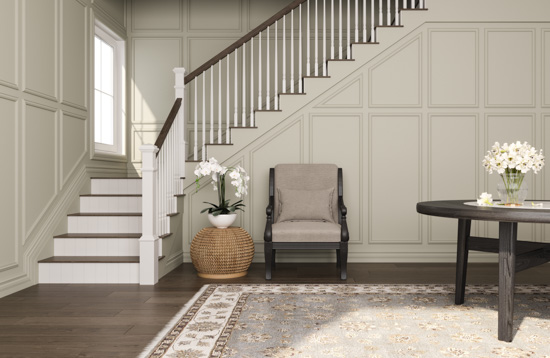 Dark toned hardwood floors leading to a staircase displaying fresh white stair risers that bend up towards the second story from the entryway.