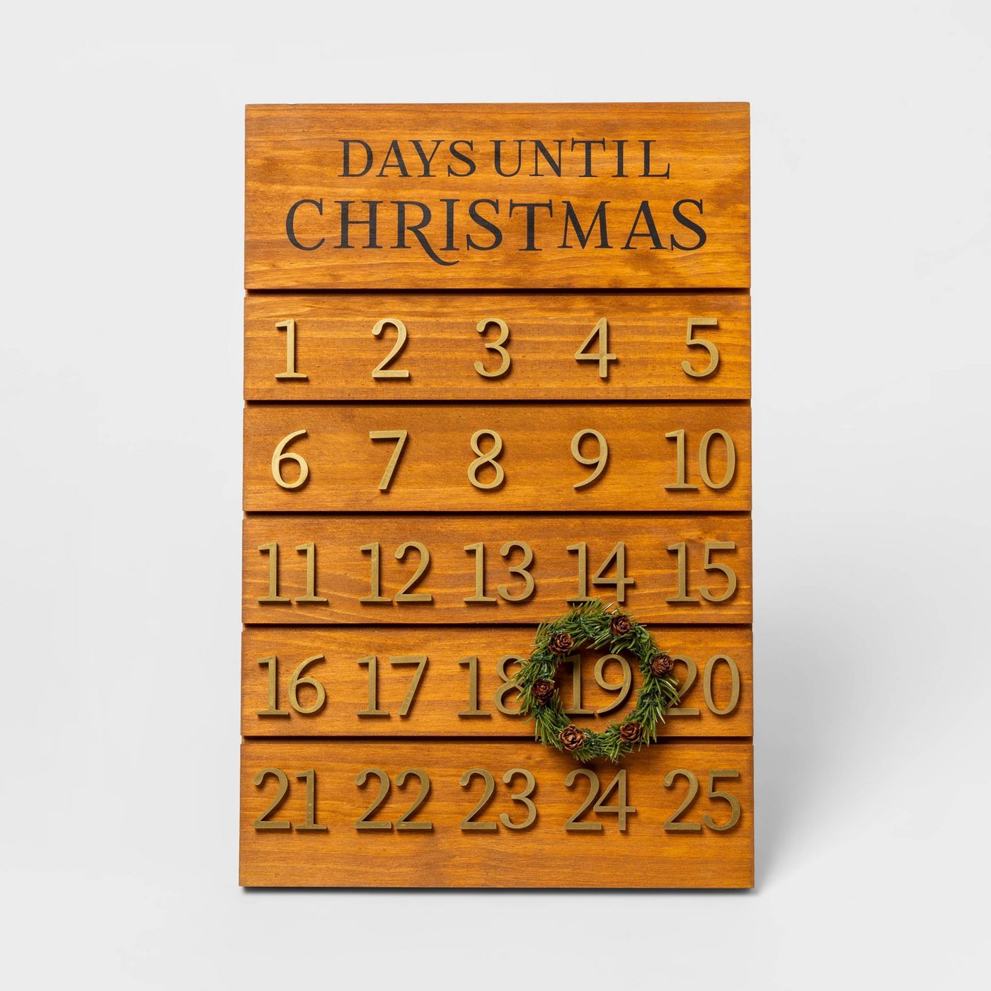 Wooden advent board with a small wreath to encircle the day of the month. 