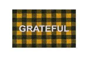 orange and black buffalo check coir mat emblazoned with the word grateful