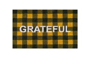 orange and black buffalo check coir mat emblazoned with the word grateful