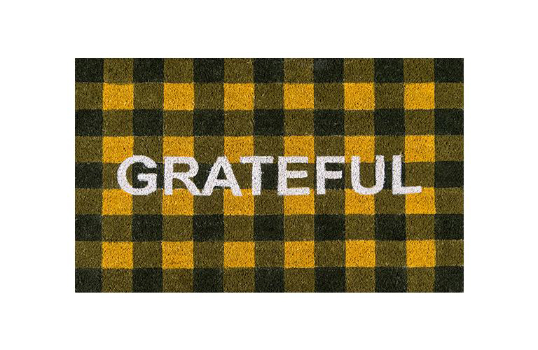 orange and black buffalo check coir mat emblazoned with the word grateful