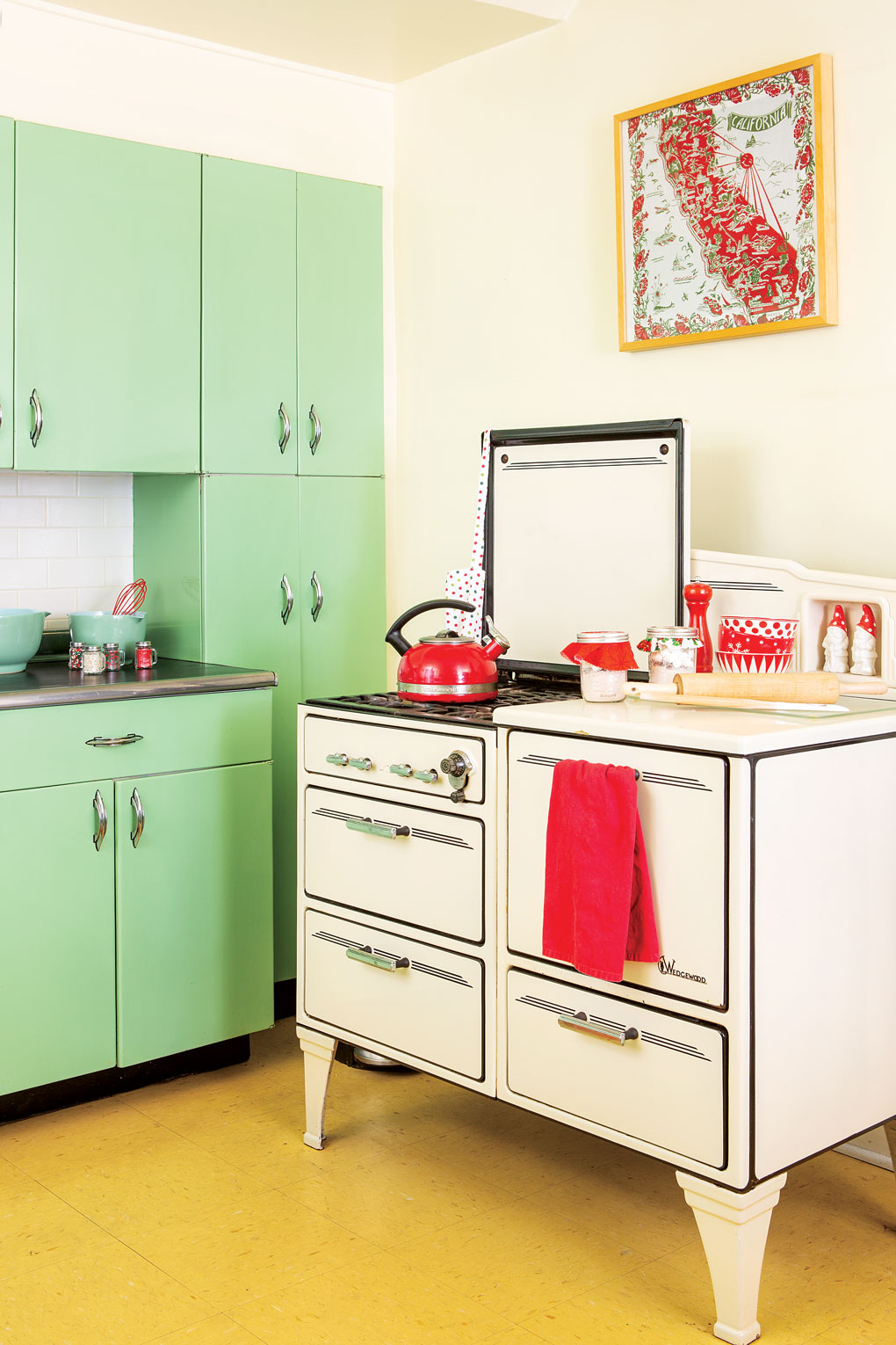 Mint green cabinetry and an antique Wedgewood gas stove in white.