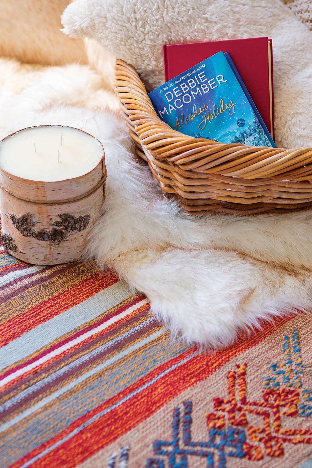 layered rugs topped with a reading basket full of blankets and books. 