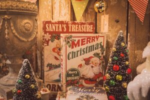 vintage santa sign and retro style christmas decor on display at a vintage market