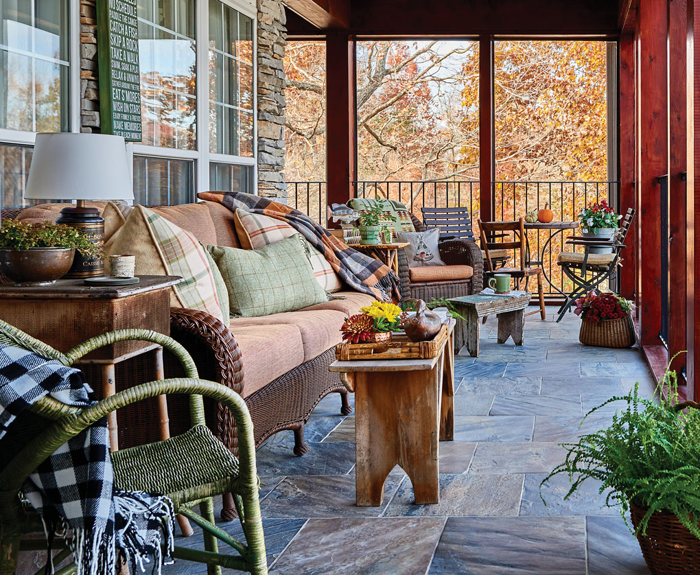 Screened in porch at a South Carolina lake house, decorated and ready for sitting and dining. 