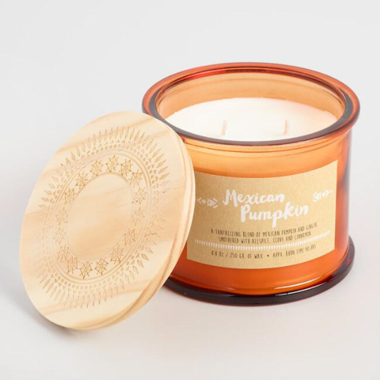 Orange glass candle in the scent "Mexican Pumpkin" with a detailed wooden lid.