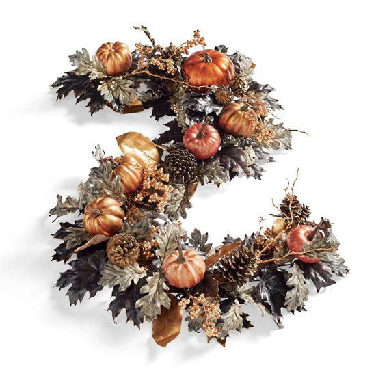 Fall garland with leaves, pinecones, twigs and small pumpkins.