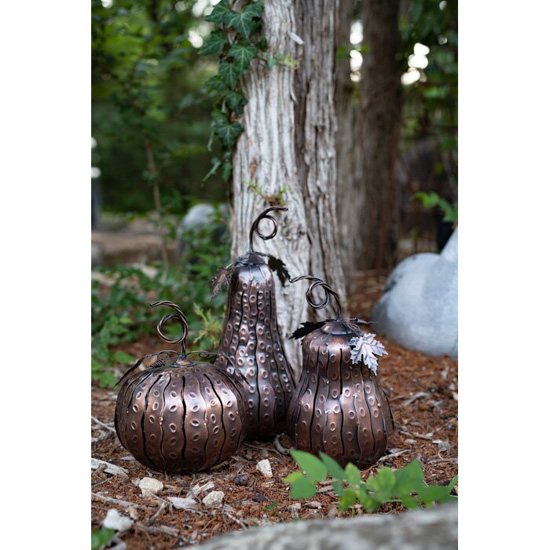 Set of three metallic luminaries in different shapes and sizes of gourds. 