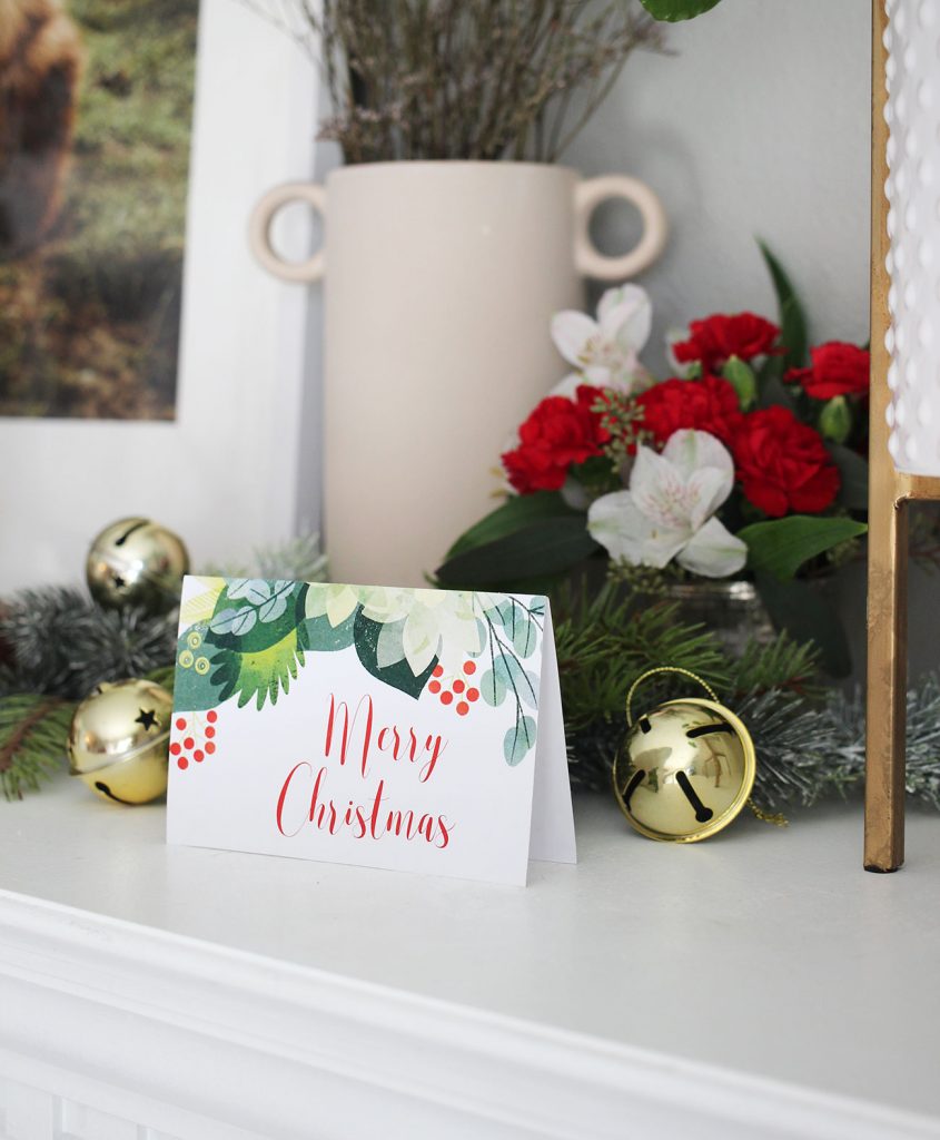 holiday card on a mantel with jingle bells