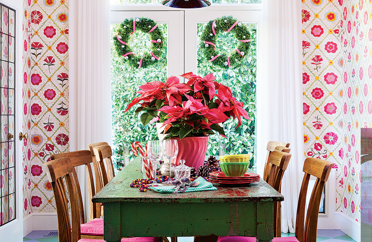 dining room with floral pattern wallpaper, painted check floors and a vintage dining table