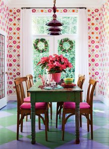 dining room with floral pattern wallpaper, painted check floors and a vintage dining table