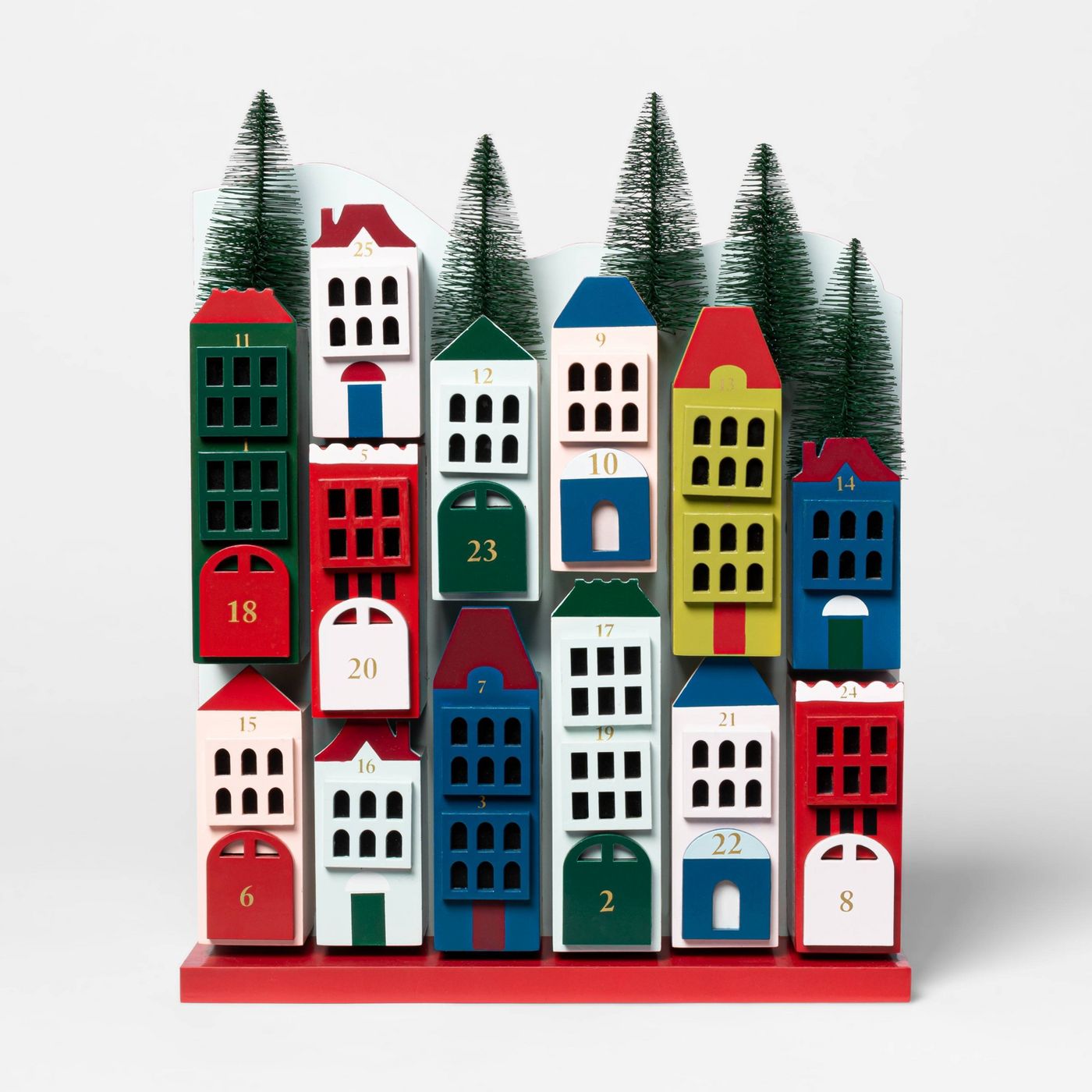 Wooden Advent Christmas village with decorative bottlebrush trees lining the top. 