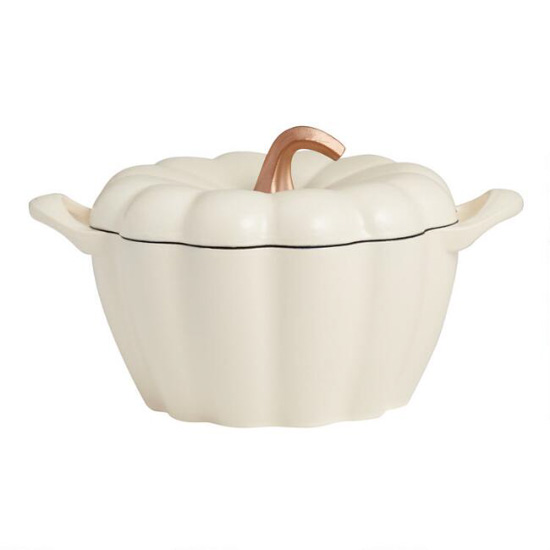White, cast iron, pumpkin shaped, dutch oven with handles and a gold accent stem. 
