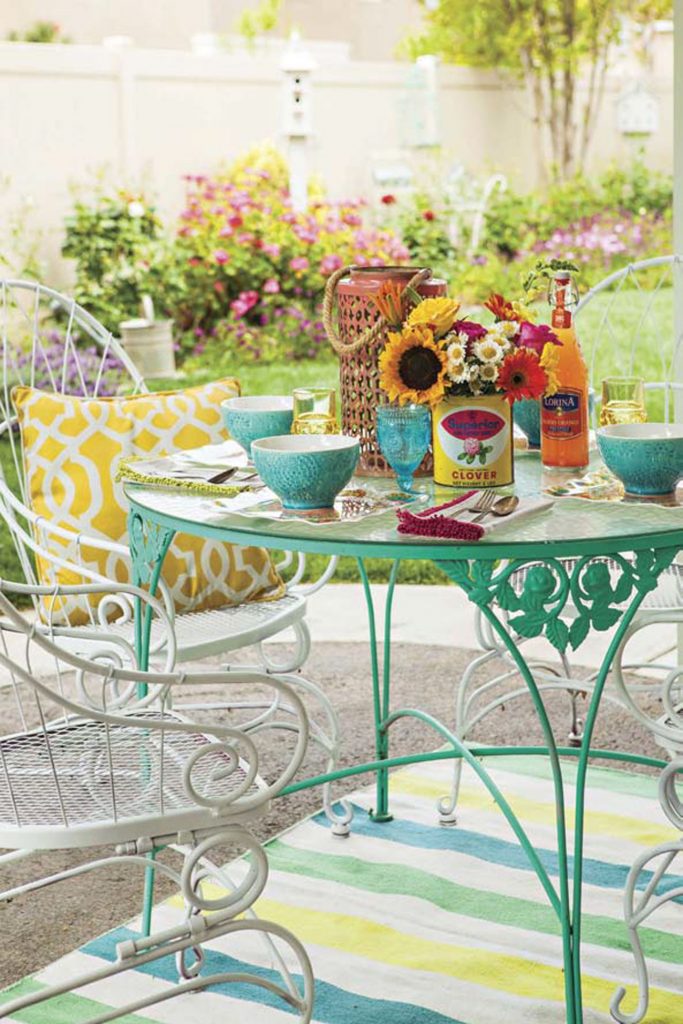 Wrought iron patio dining set topped with a brunch spread.