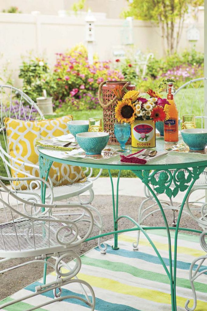 Wrought iron patio dining set topped with a brunch spread. 