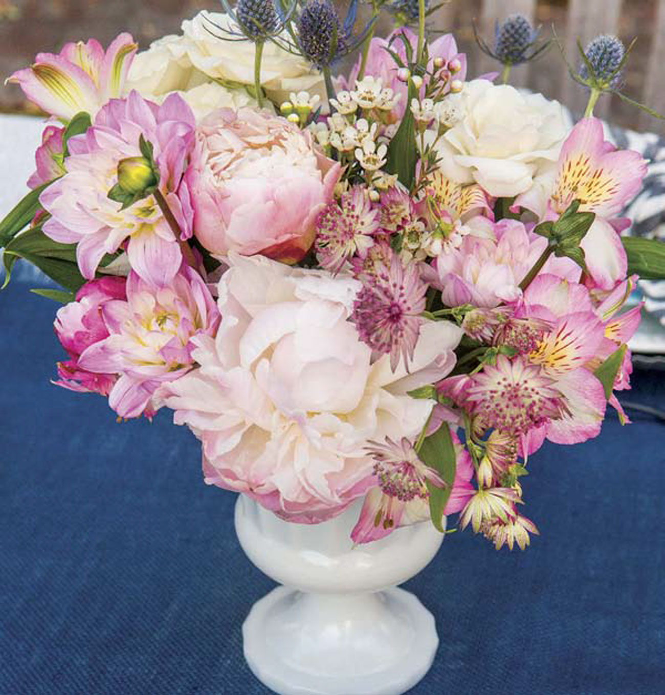 Peonies, dahlias, alstroemeria, Scottish thistles, roses and wax flowers combine for a tone-on-tone arrangement