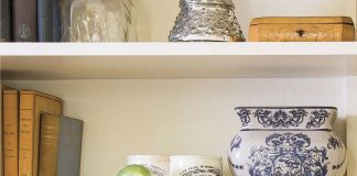 Keiller Dundee marmalade jars arranged on a shelving space alongside books and antique vases.