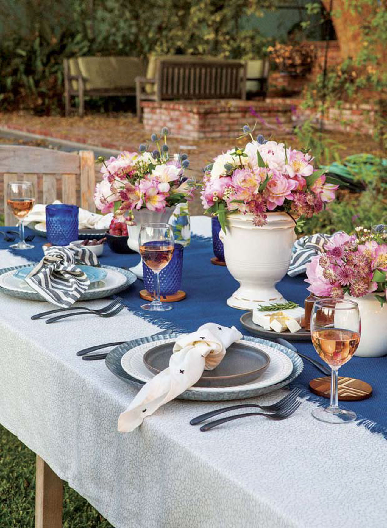 wooden coasters, cobalt-blue glasses and a piece of rosemary-topped brie with honey